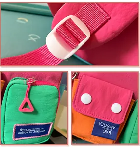Macro detail of pink nylon backpack featuring white adjustable buckle and brand patch