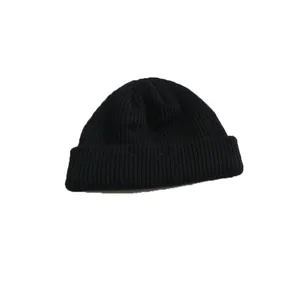 Classic black short knitted beanie hat, stylish cuffed melon skin cap for men and women.