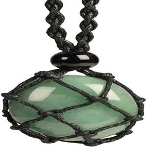Macro view of polished green gemstone held in a handmade black woven mesh pocket