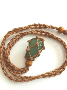 Detailed view of hand-woven brown net holding a smooth green natural stone pendant