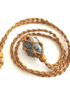 Hand-woven adjustable mesh pouch necklace with a polished natural blue crystal stone
