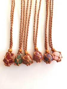 Detail view of handmade woven net necklaces with assorted natural crystal stone pendants.