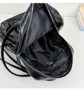 Detail view of large capacity black leather backpack with inner zipper pocket