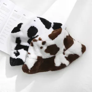 High detail macro view of soft plush cow print bucket hats for winter season warmth