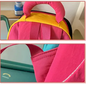 Close-up detail of reinforced stitching on pink and yellow nylon backpack straps