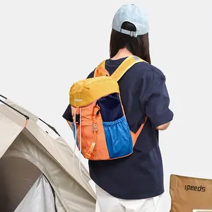 Large multi-colored casual backpack shown in an outdoor camping lifestyle scene