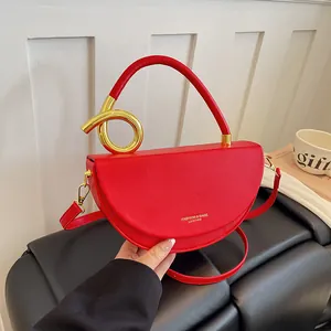 Detailansicht einer roten Satteltasche aus Leder mit einzigartigem goldfarbenem Ring.