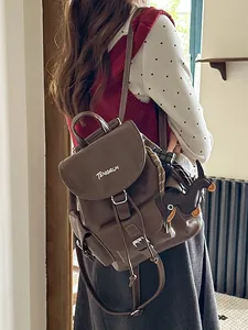 Vintage brown leather backpack with dog charm for stylish daily commute by Tengrun