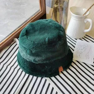 Detailed view of a deep green plush bucket hat with soft faux fur texture for winter.