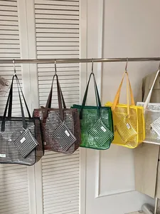Minimalist large capacity grid tote bags in multiple colors hanging on a clothing rack