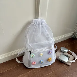 Stylish white mesh drawstring backpack with colorful crochet flowers in lifestyle scene