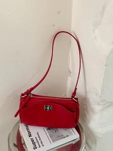 Sac à bandoulière rouge chic de style français minimaliste sur une table d'appoint