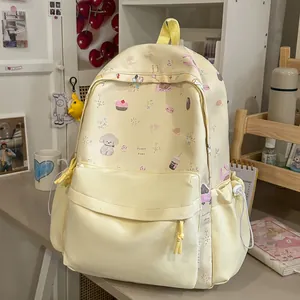 Cute cream-colored backpack with sweet cartoon patterns on a student desk environment