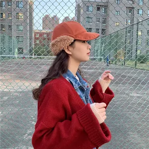 Cute Japanese style winter trapper hat with warm plush ear flaps shown on model outdoors
