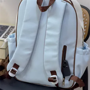 Detailed back view of a light blue school backpack featuring a hidden zipper pocket