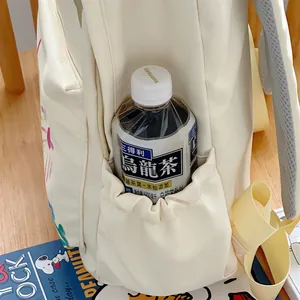 Close-up detail of a cream beige backpack side pocket showing elastic compartment