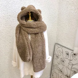 Close-up of cozy brown teddy bear hooded scarf on a white mannequin display.