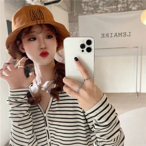 Asian model wearing a brown bucket hat with cute rabbit ear design in a mirror selfie