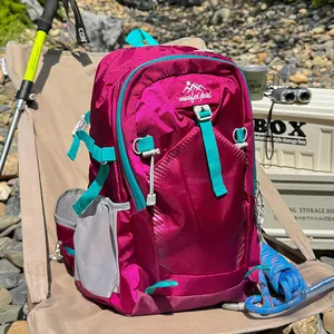 Outdoor waterproof hiking backpack for women in magenta with turquoise straps