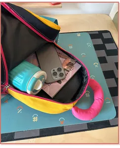 Interior view of a vibrant high-capacity backpack showing storage for bottle and phone.