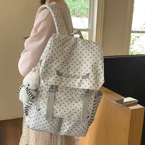 Close-up of stylish star pattern backpack with cute plush bear keychain accessory