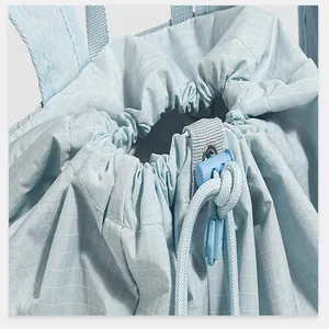 Close-up detail of light blue checkered drawstring bag closure with plastic toggle