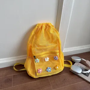 Vibrant yellow mesh drawstring backpack adorned with cute colorful crochet flowers detail