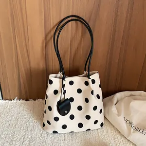 French retro cream and black polka dot tote bag with a matching small charm pouch