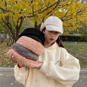 Variety of warm winter fleece earflap hats shown in a cozy outdoor autumn setting