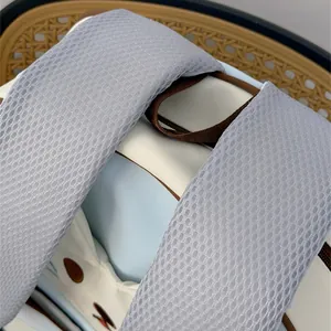 Close-up of breathable mesh shoulder straps on a cute blue and white cat backpack.
