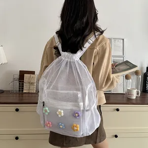 Stylish white mesh drawstring backpack featuring colorful crochet flower patches.