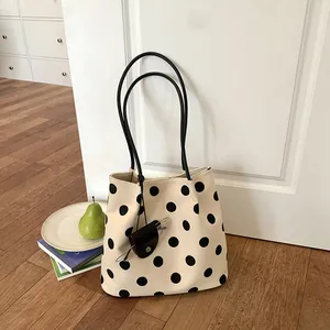 Retro French style polka dot shoulder bag displayed in a clean lifestyle room setting
