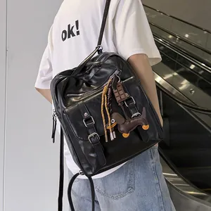 Back view of a person wearing a black large-capacity commuter backpack with cute charms.