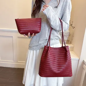 Model holding a premium red woven tote bag and matching clutch set details