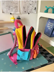 Detail view showing multi-compartment interior of a colorful student backpack