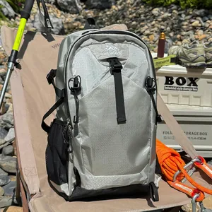 Detailed view of a silver lightweight waterproof hiking backpack in an outdoor setting