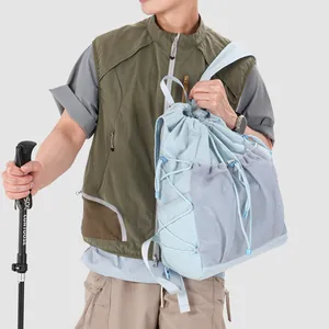 Detail view of light blue drawstring backpack with mesh pockets for outdoor hiking