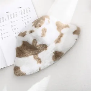 Detailed macro view showing the soft texture and cow print of this winter plush bucket hat