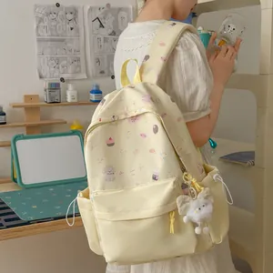 Sweet aesthetic yellow backpack with cute prints and white fuzzy bow charm detail
