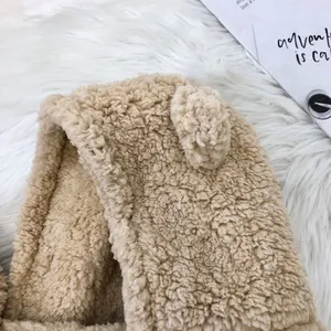 Close-up detail of the plush bear ear hat showing the soft and cozy beige fleece texture