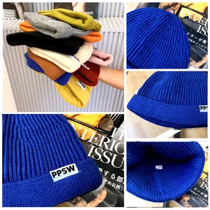 Detailed views of multi-colored children's knitted beanie caps with PPSW labels