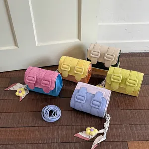 Fashionable color-block mini crossbody bags in various pastel shades with floral charms.