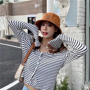 Close-up of a cute orange bucket hat with rabbit ear embroidery worn by a model