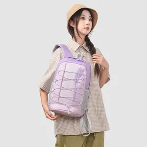 Detail shot of a purple outdoor sports backpack with elastic cords worn by a model