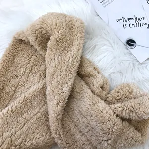 Close-up of soft tan plush fleece material of the hooded scarf with ear protection