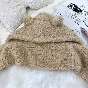 Close-up of cute bear-eared fleece hooded scarf for women in beige winter style