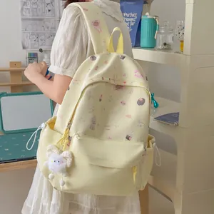 Side view of a cute yellow student backpack with sweet bear and rabbit prints