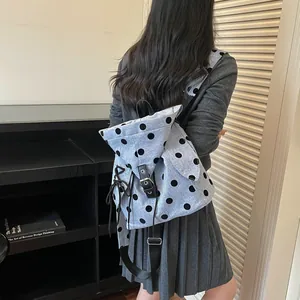 Lifestyle view of women's light blue polka dot backpack for school or commuting