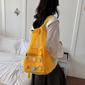 Detailed view showing the yellow mesh fabric and colorful flower patches on the backpack strap