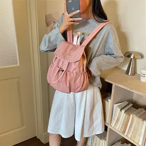 Close-up detail of the stylish pink drawstring backpack for students and travel use